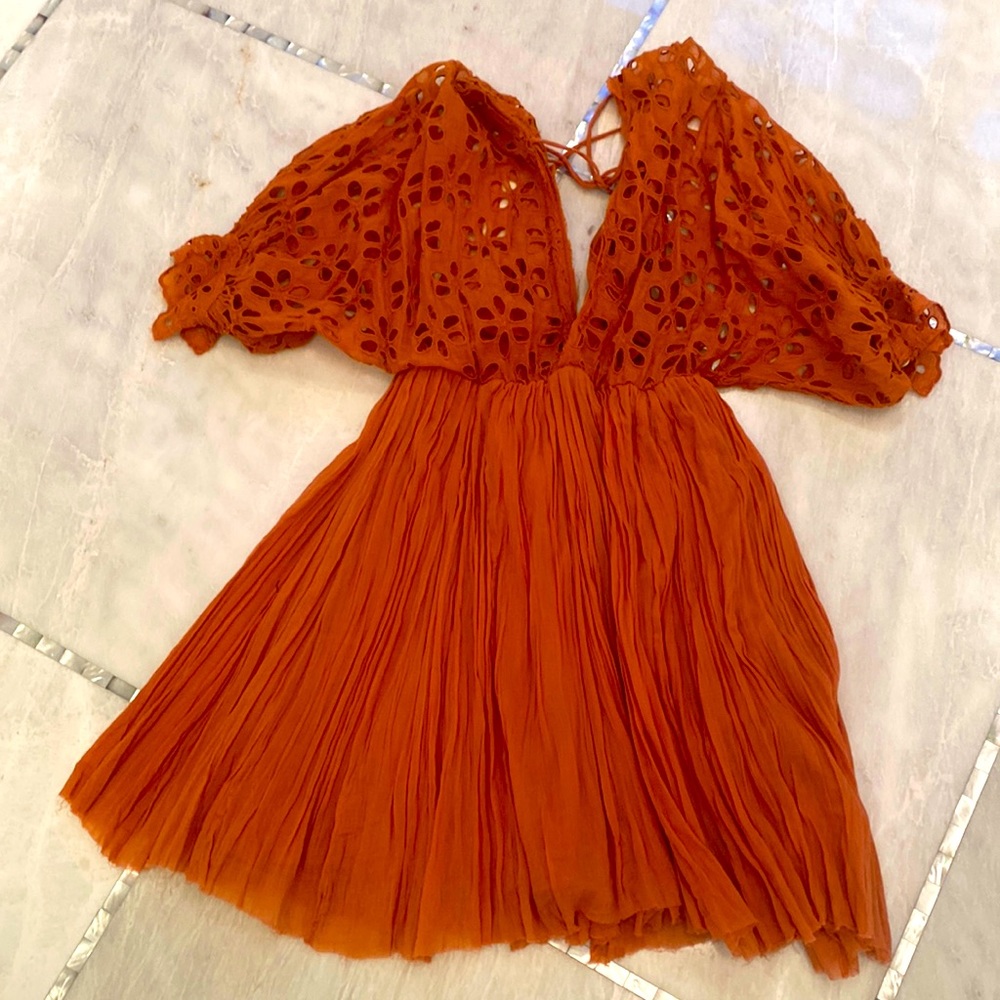 FPOne Burnt orange gathered mini dress with floral cutout sleeve detail.
